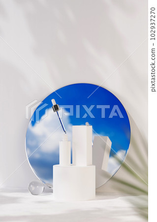 Mockup scene for cosmetic with bottle unlabeled with dropper cap on white podium. Behind is a mirror reflecting the blue sky and white clouds, on white background and natural shadow leaves. Mockup scene for cosmetic with bottle unlabeled with dropper cap on white podium. Behind is a mirror reflecting the blue sky and white clouds, on white background and natural shadow leaves. 102937270