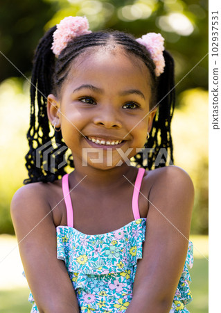 Closeup portrait of smiling african american cute girl with dreadlocks looking away Closeup portrait of smiling african american cute girl with dreadlocks looking away 102937531