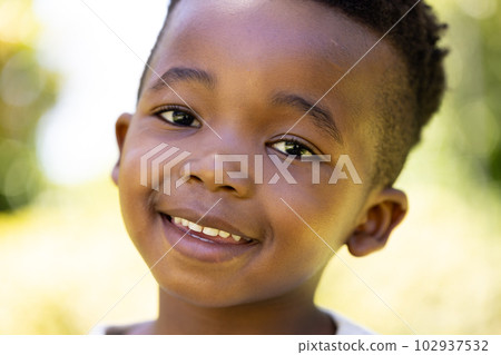 Closeup portrait of cute african american smiling boy looking at camera 102937532