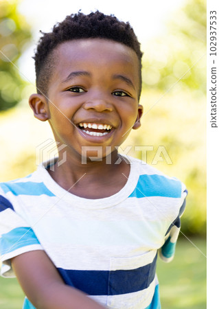 Closeup portrait of cheerful african american cute boy smiling and looking at camera 102937533