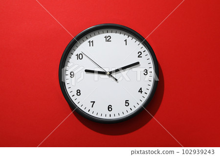 Concept of time change with clock on red background Concept of time change with clock on red background 102939243
