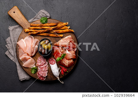 Antipasto board with various meat and snacks Antipasto board with various meat and snacks 102939664