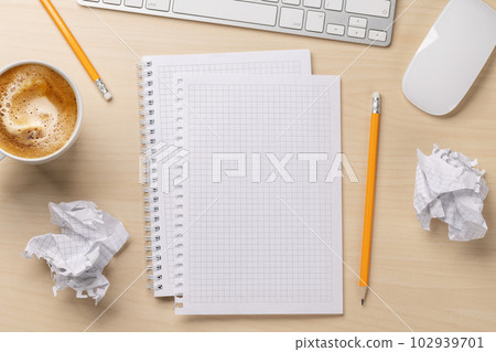 Top view of blank notepad, keyboard, coffee and crumpled papers Top view of blank notepad, keyboard, coffee and crumpled papers 102939701