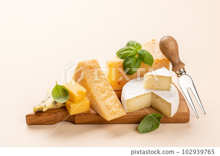 Various cheese on board 102939765