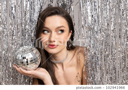 Young woman with disco ball, close up Young woman with disco ball, close up 102941966
