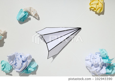 Paper plane and paper balls on white background 102943390