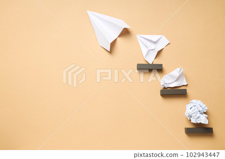 Business, startup and sponsorship concept with paper planes and paper on beige background Business, startup and sponsorship concept with paper planes and paper on beige background 102943447