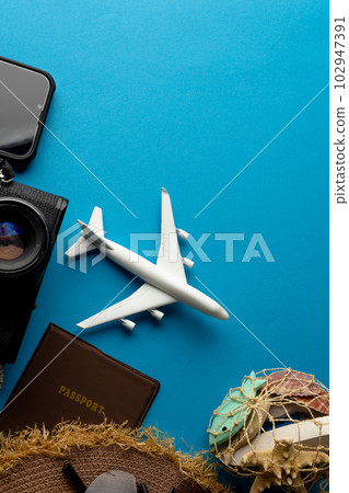 Airplane model with sunglasses, passport, camera and smartphone on blue background with copy space Airplane model with sunglasses, passport, camera and smartphone on blue background with copy space 102947391