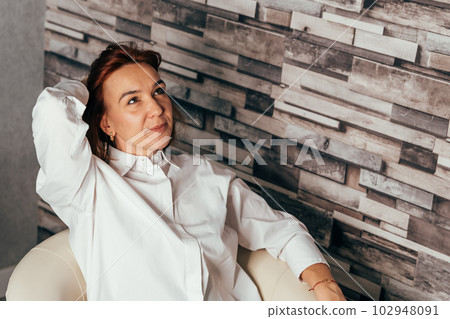 Distracted from work worried young woman sitting on couch 102948091