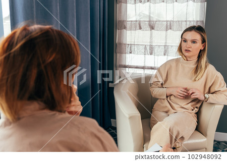 Two young women talking in a consultation. Female colleagues Two young women talking in a consultation. Female colleagues 102948092