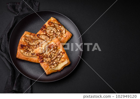 Delicious fresh sweet pie or pizza with pear, brie cheese, honey and nuts Delicious fresh sweet pie or pizza with pear, brie cheese, honey and nuts 102949120