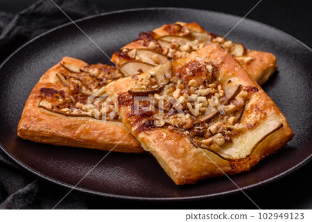 Delicious fresh sweet pie or pizza with pear, brie cheese, honey and nuts Delicious fresh sweet pie or pizza with pear, brie cheese, honey and nuts 102949123