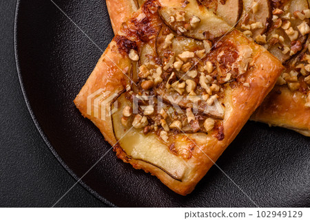 Delicious fresh sweet pie or pizza with pear, brie cheese, honey and nuts 102949129
