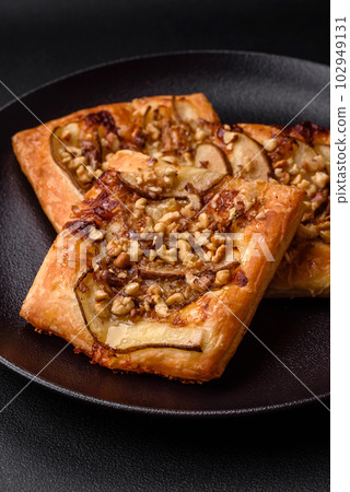 Delicious fresh sweet pie or pizza with pear, brie cheese, honey and nuts 102949131