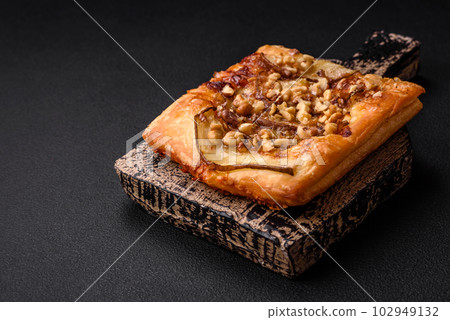 Delicious fresh sweet pie or pizza with pear, brie cheese, honey and nuts 102949132