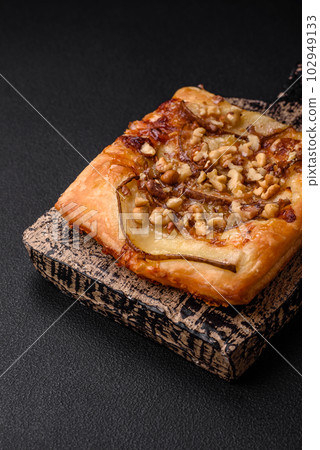 Delicious fresh sweet pie or pizza with pear, brie cheese, honey and nuts 102949133