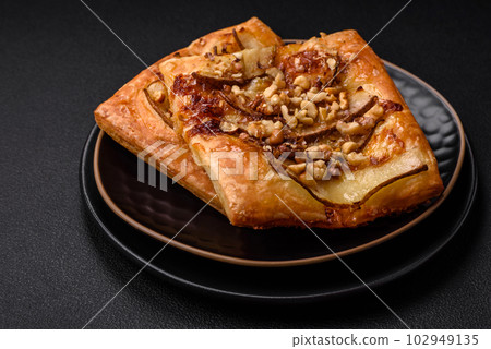 Delicious fresh sweet pie or pizza with pear, brie cheese, honey and nuts 102949135
