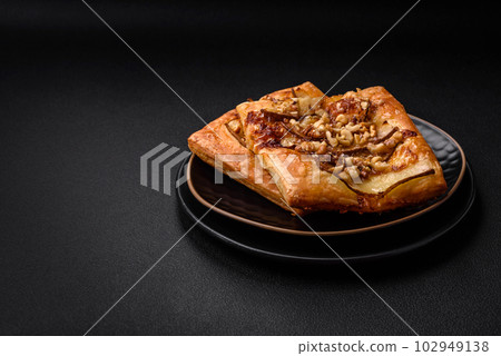 Delicious fresh sweet pie or pizza with pear, brie cheese, honey and nuts Delicious fresh sweet pie or pizza with pear, brie cheese, honey and nuts 102949138