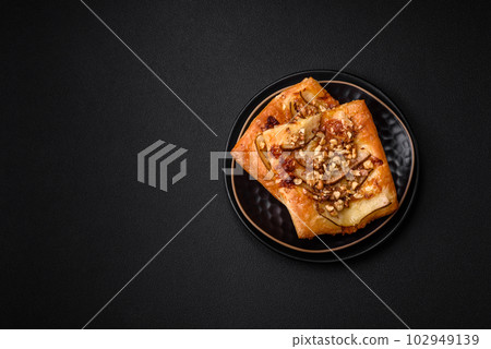 Delicious fresh sweet pie or pizza with pear, brie cheese, honey and nuts 102949139