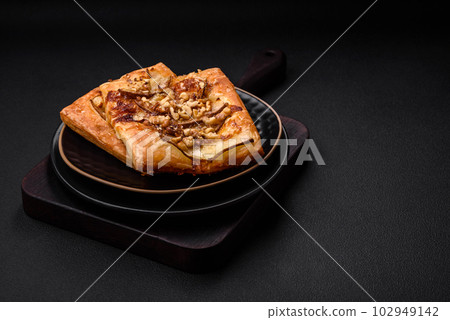 Delicious fresh sweet pie or pizza with pear, brie cheese, honey and nuts Delicious fresh sweet pie or pizza with pear, brie cheese, honey and nuts 102949142