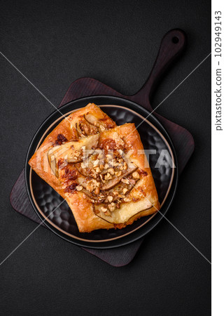 Delicious fresh sweet pie or pizza with pear, brie cheese, honey and nuts Delicious fresh sweet pie or pizza with pear, brie cheese, honey and nuts 102949143