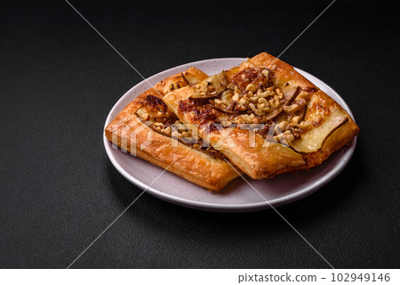 Delicious fresh sweet pie or pizza with pear, brie cheese, honey and nuts 102949146