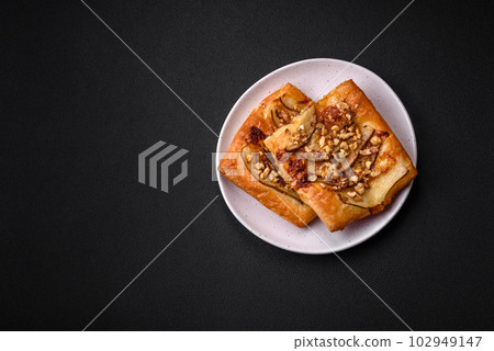 Delicious fresh sweet pie or pizza with pear, brie cheese, honey and nuts Delicious fresh sweet pie or pizza with pear, brie cheese, honey and nuts 102949147
