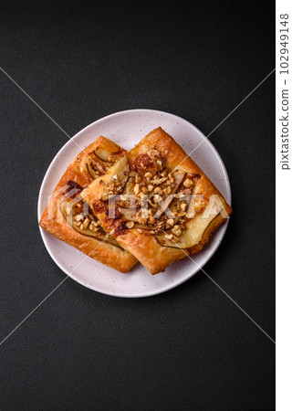 Delicious fresh sweet pie or pizza with pear, brie cheese, honey and nuts Delicious fresh sweet pie or pizza with pear, brie cheese, honey and nuts 102949148