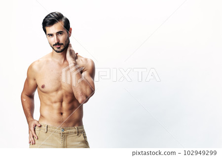 Man athlete model with a naked torso and six pack abs sporty inflated figure and tan on a white isolated background, fashionable clothing style, copy space, space for text 102949299