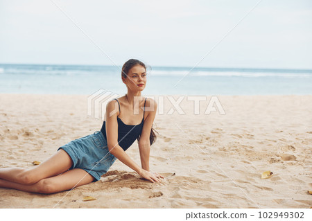 woman sand travel tan smile vacation sea beach freedom sitting nature 102949302