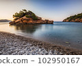 Smooth water and the small island. 102950167