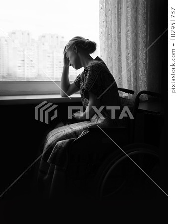 Sad girl at the window 102951737