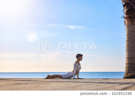 Sporty Middle Aged Woman Practicing Yoga Outdoors, Athletic Female In Activewear Exercising On Sporty Middle Aged Woman Practicing Yoga Outdoors, Athletic Female In Activewear Exercising On 102952298