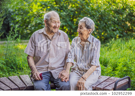 Elderly couple in love. Senior husband and wife holding hands and bonding with true emotions Elderly couple in love. Senior husband and wife holding hands and bonding with true emotions 102952299