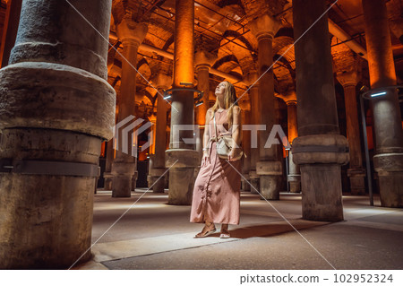 Woman tourist enjoying Beautiful cistern in Istanbul. Cistern - underground water reservoir build in 6th century, Istanbul, Turkey, Turkiye Woman tourist enjoying Beautiful cistern in Istanbul. Cistern - underground water reservoir build in 6th century, Istanbul, Turkey, Turkiye 102952324