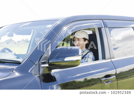 A woman sitting in the passenger seat in a drive A woman sitting in the passenger seat in a drive 102952389