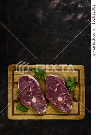 Patagonian lamb meat presented on the wooden table, Patagonia Argentina. Patagonian lamb meat presented on the wooden table, Patagonia Argentina. 102952392