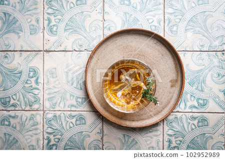 Glass of whiskey with ice 102952989
