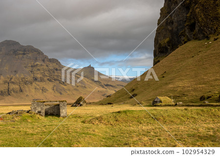 Rock with a grass and moss in the autumn, Iceland 102954329