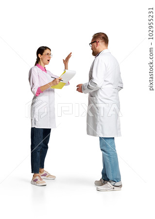 Portrait of woman and man, doctors in white lab coat arguit on medical questions isolated over white background 102955231