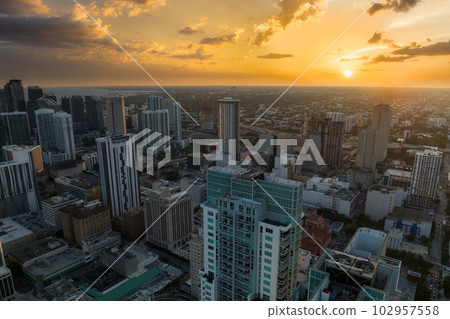 Aerial view of downtown office district of Miami Brickell in Florida, USA at sunset. High commercial and residential skyscraper buildings in modern american megapolis Aerial view of downtown office district of Miami Brickell in Florida, USA at sunset. High commercial and residential skyscraper buildings in modern american megapolis 102957558