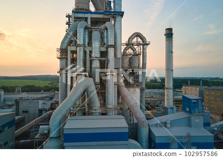 Aerial view of cement factory with high concrete plant structure and tower crane at industrial production site. Manufacture and global industry concept 102957586