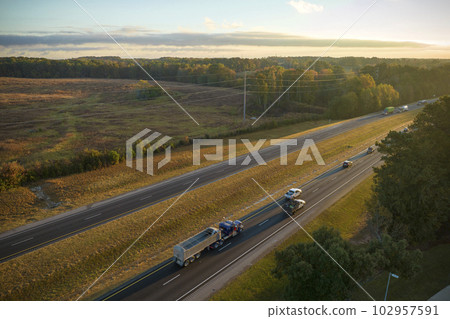 Aerial view of busy american highway with fast moving traffic. Interstate transportation concept Aerial view of busy american highway with fast moving traffic. Interstate transportation concept 102957591