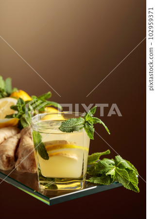 Refreshing summer cocktail with natural ice, ginger, lemon, and mint. 102959371