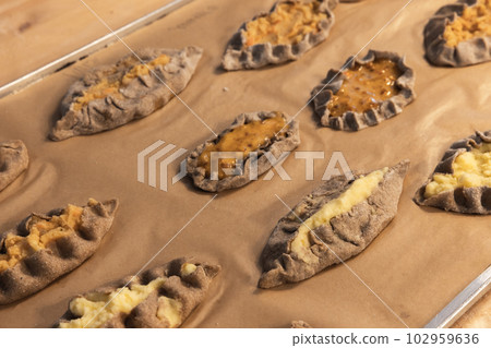 Karelian pasties with mashed potato and carrot, close up 102959636