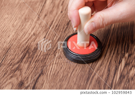 [Woman putting ink on seal] 102959843