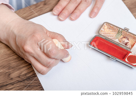 [Woman stamping the stamp with case] 102959845