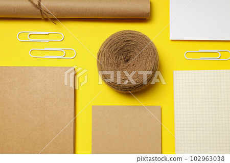 Mockup flat lay with different office accessories on yellow background Mockup flat lay with different office accessories on yellow background 102963038