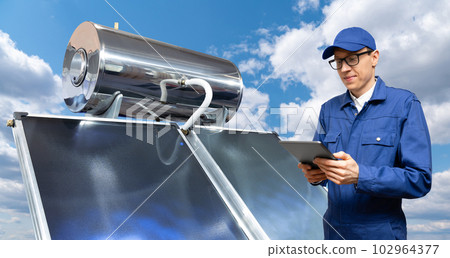 Worker with digital tablet next to with solar collector Worker with digital tablet next to with solar collector 102964377
