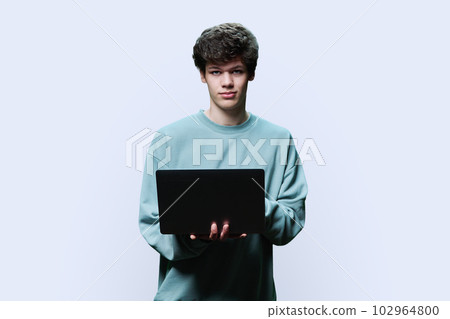 Young male college student using laptop, white studio background Young male college student using laptop, white studio background 102964800